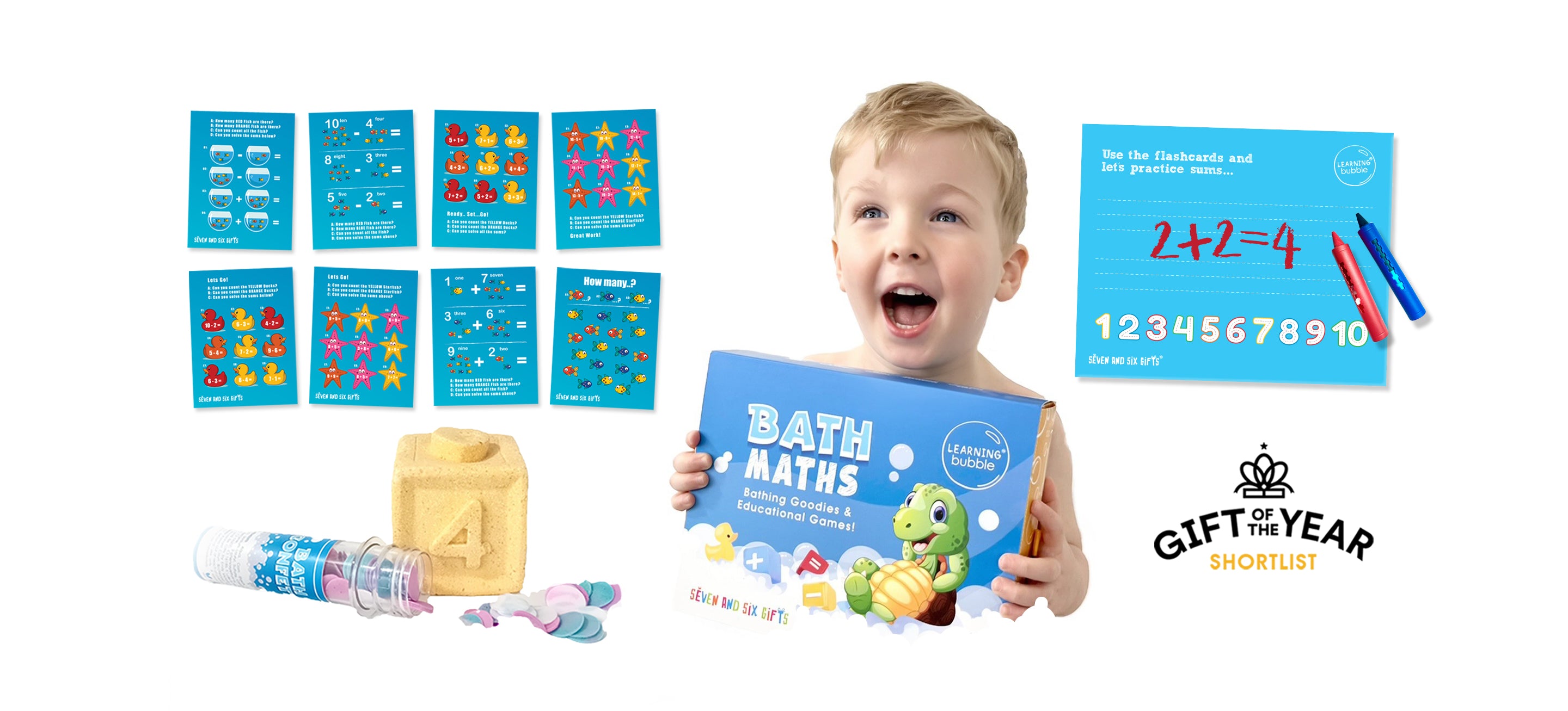 Child holding a bath math educational toy with educational flashcards and bath crayons on a white background