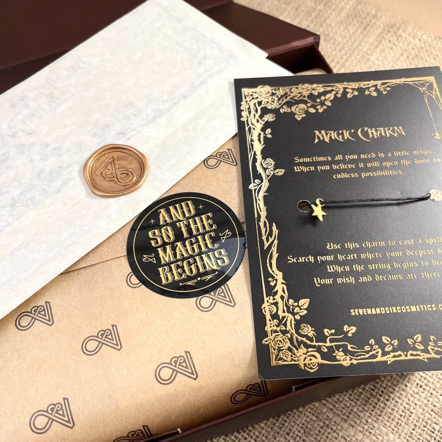 Magical wish charm bracelet with spell card and wax-sealed acceptance letter from wizardry school, included in a magical gift set for witches and wizards