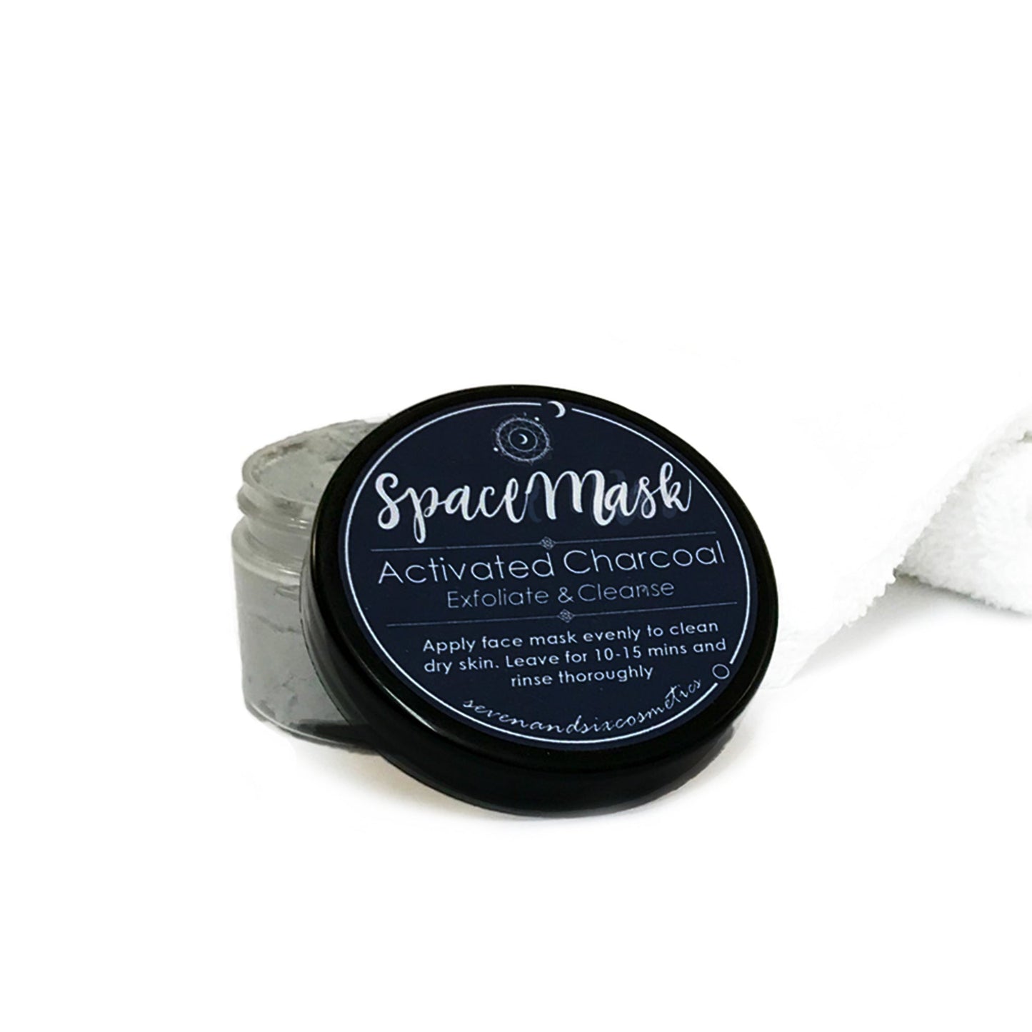 Astrology-themed facemask placed on a white towel, styled as part of a luxurious pamper gift set.