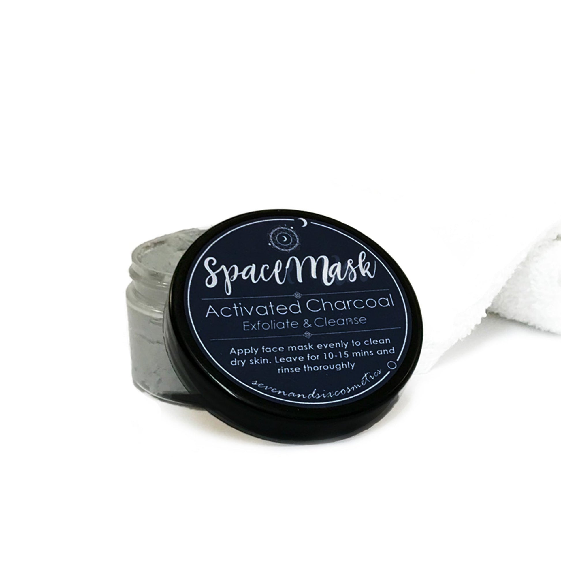 Astrology-themed facemask placed on a white towel, styled as part of a luxurious pamper gift set.