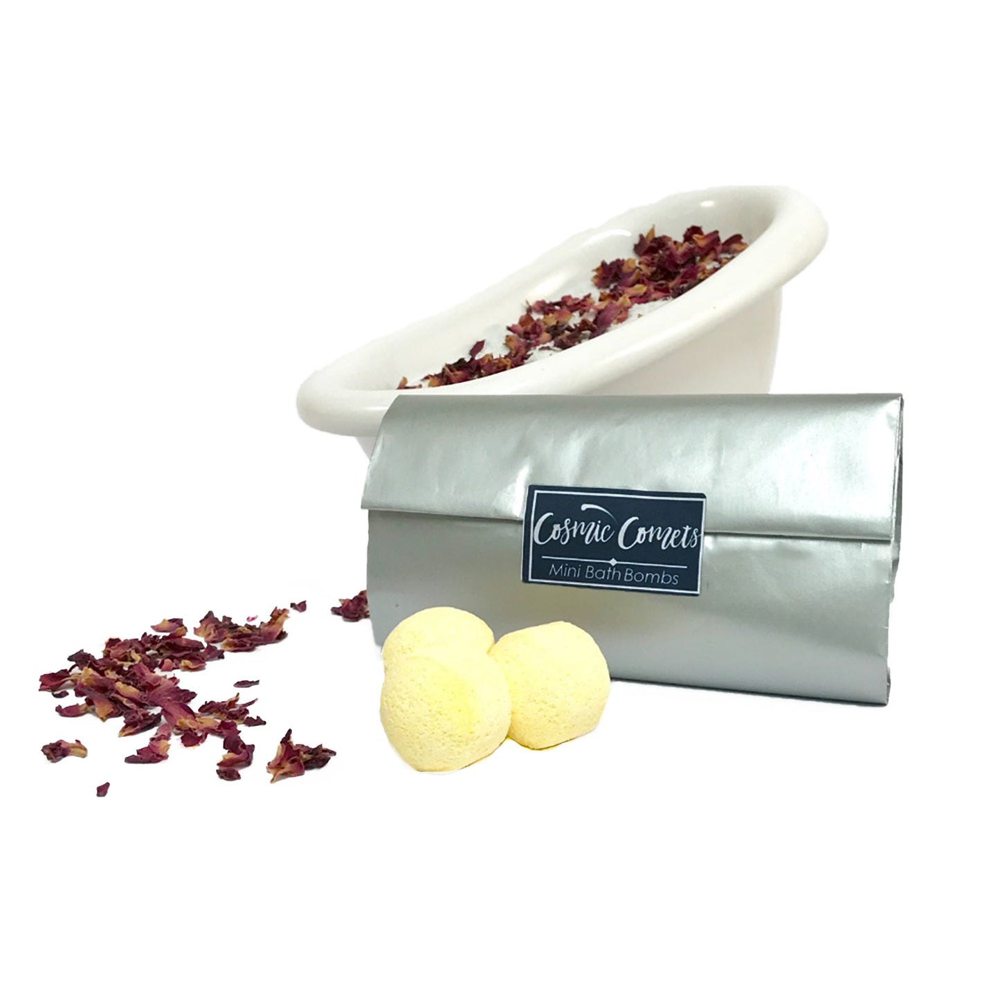 Zodiac Cosmic Comet bath bombs in a bath surrounded by rose petals, creating a colorful and relaxing spa experience